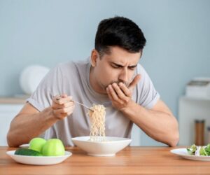Man making a disgusted face while eating because everything tastes salty