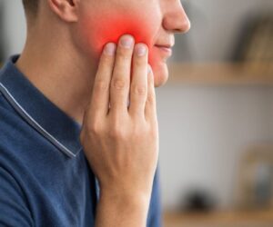 The man is experiencing toothache.