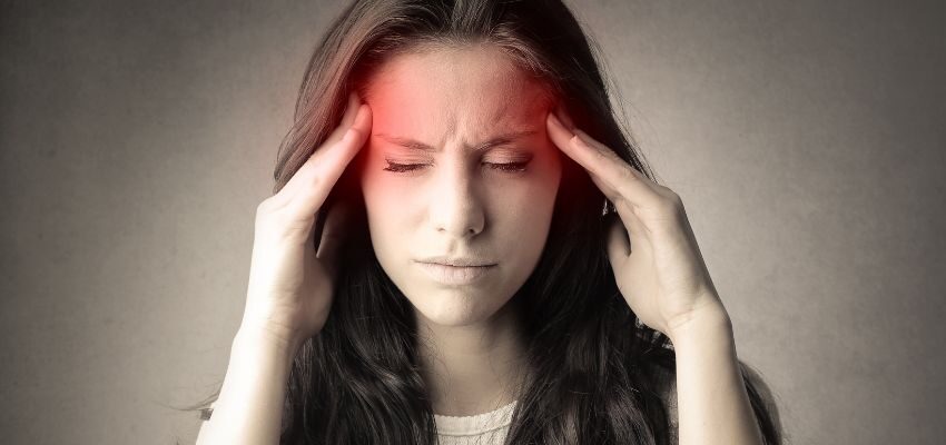 The woman is experiencing a headache while having toothache.