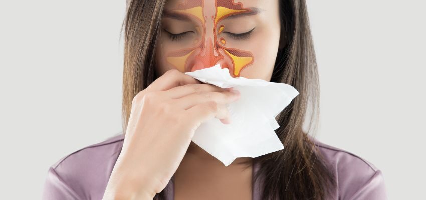 The woman has an acute nasal obstruction, often resulting from swollen nasal tissues due to a virus or allergies.