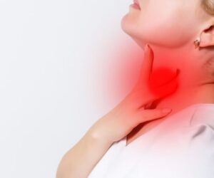 The woman is not feeling well because of strep throat.