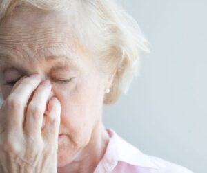 The older woman suffers from sinus allergies.