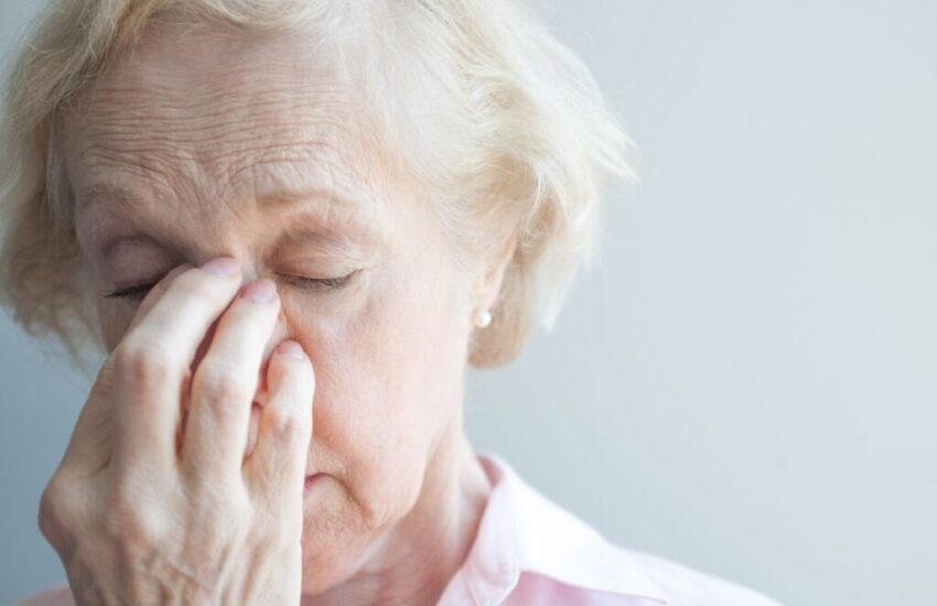 The older woman suffers from sinus allergies.