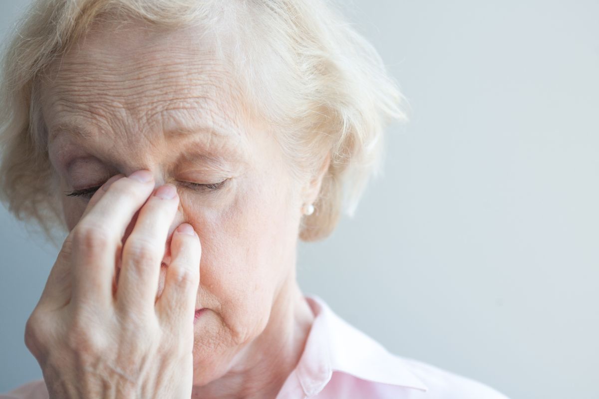 The older woman suffers from sinus allergies.