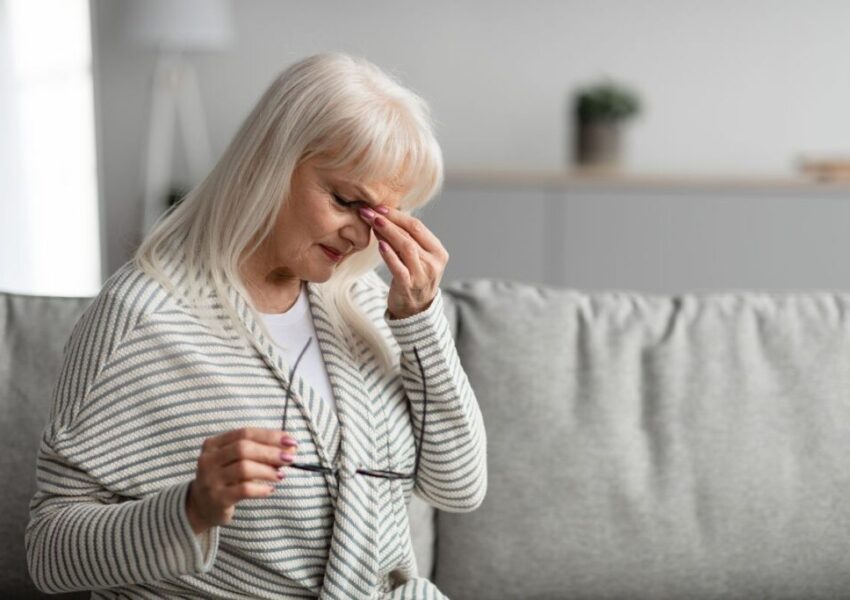 The aged woman feels a dry nose.