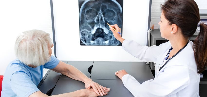 The doctor reads the X-ray result, which shows a sinus infection.