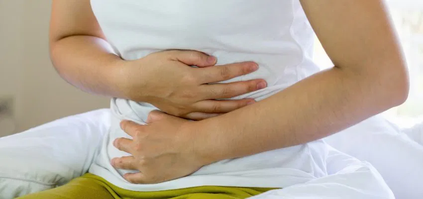 A woman eating sweet foods to get rid of salty taste in mouth.