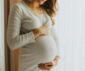 The pregnant woman is happy with her healthy pregnancy.