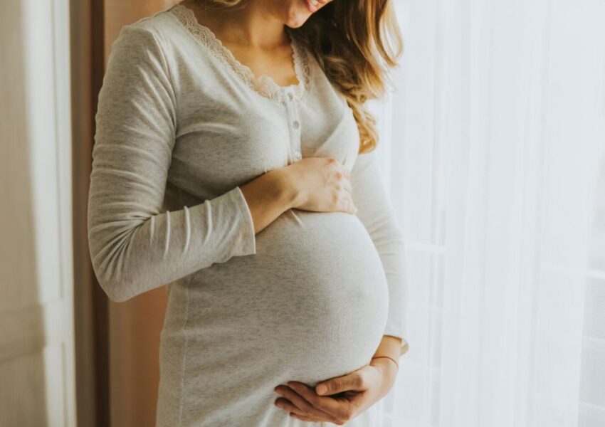 The pregnant woman is happy with her healthy pregnancy.