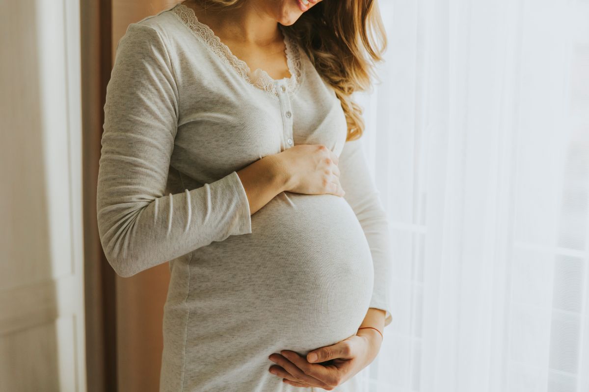 The pregnant woman is happy with her healthy pregnancy.