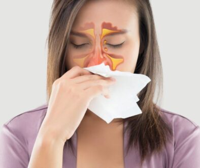 Woman with sinus pain and nasal congestion, illustrating crackling sound in sinuses