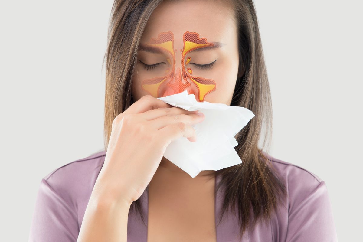 Woman with sinus pain and nasal congestion, illustrating crackling sound in sinuses