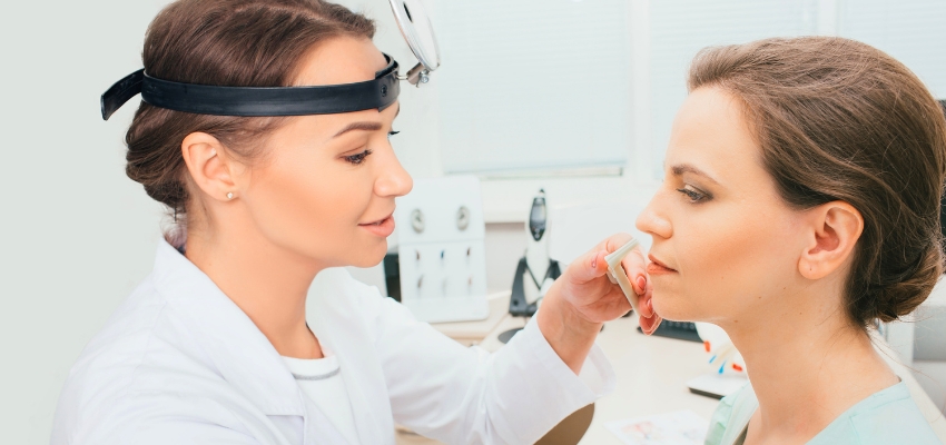 Doctor examining a patient’s sinuses to evaluate if prednisone for sinus infection is appropriate.