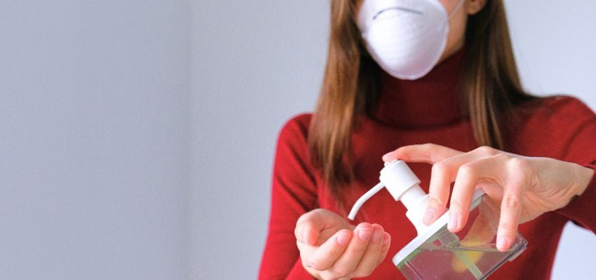 sickness going around (2) The woman uses sanitizer to prevent the spread of the virus.