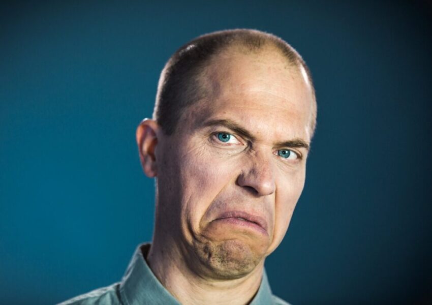A man expressing disgust at someone who can't stop the protein farts from coming.