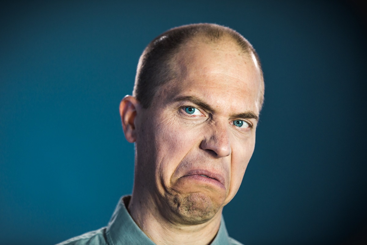 A man expressing disgust at someone who can't stop the protein farts from coming.