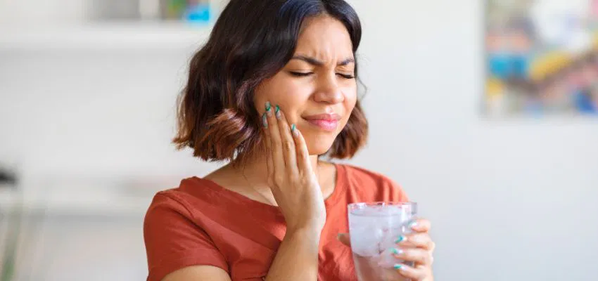 A woman uses natural remedies to treat mouth ulcers.
