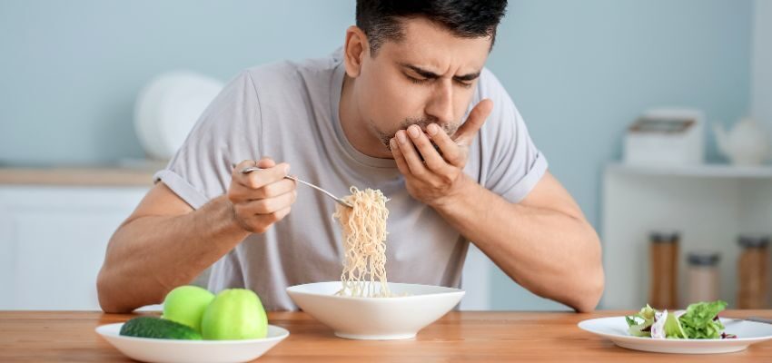 The man can't taste his food because of the flu.