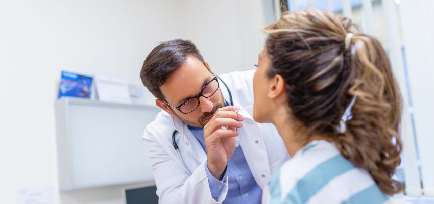 The doctor examined the woman's throat.