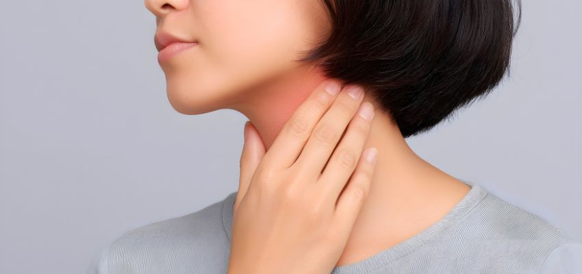 The woman has a sore throat.