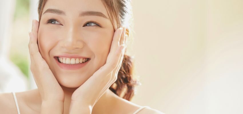 The woman's skin is clear because of taking probiotic supplements.