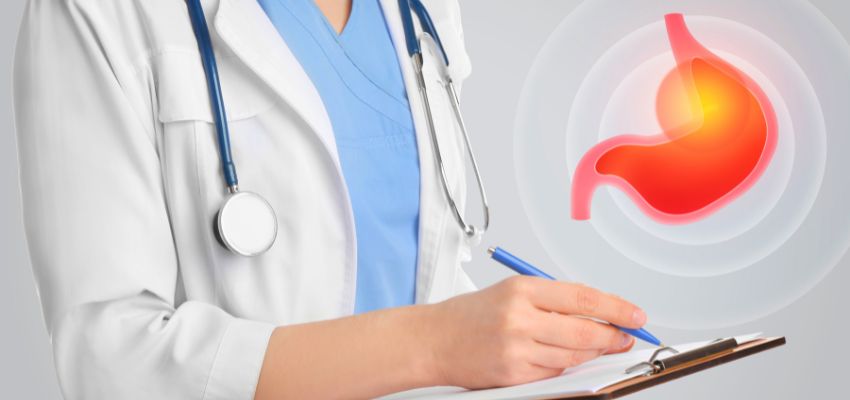 Medical professional in scrubs holding a clipboard and pen, with a glowing red-orange illustration of a stomach superimposed in the foreground, representing the diagnosis and management of a GERD flare up in clinical practice