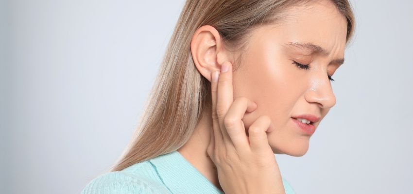 The woman's ear hurt.