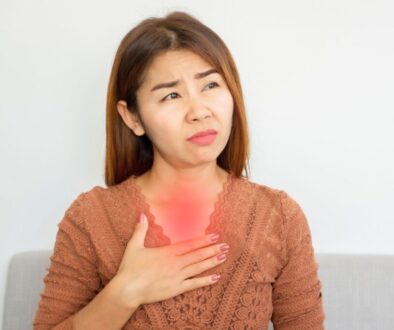 The woman is experiencing acid reflux.