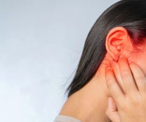 The woman has symptoms of Acute otitis media.