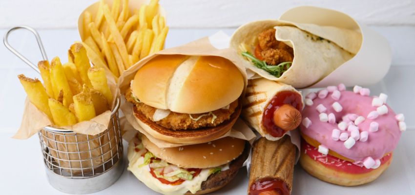 Burgers, french fries, hot dogs, burrito, and donut – classic examples of worst foods for gut health