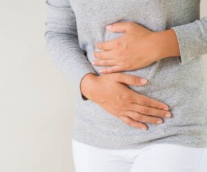 The woman is experiencing symptoms of gut inflammation.