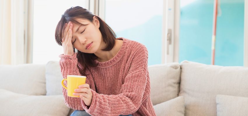 The woman is experiencing fatigue due to gut inflammation.