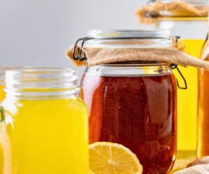 Is kombucha good for gut health shown with homemade kombucha jars, bright yellow lemonade, and fresh lemon