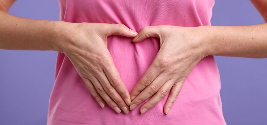 Is kombucha good for gut health illustrated by hands forming a heart over the stomach area