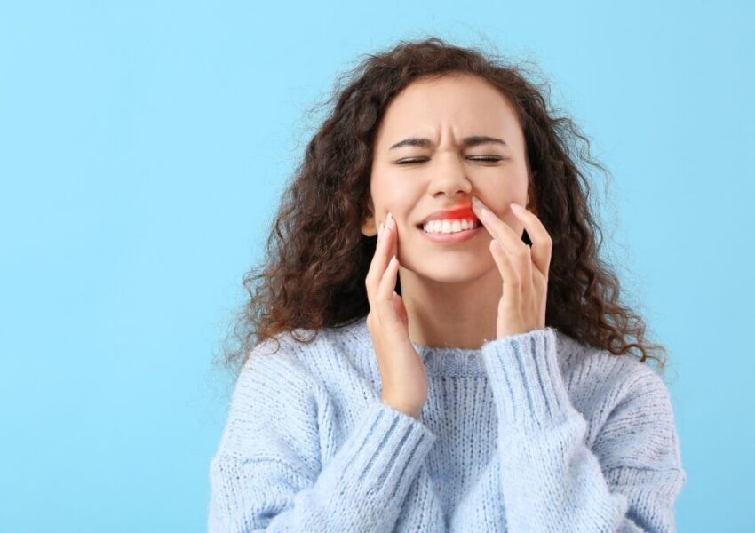 The woman is experiencing periodontal disease.