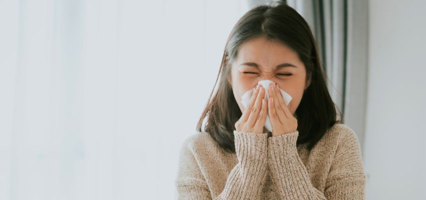 Woman with congestion seeking relief and guidance on how often can you use a neti pot.